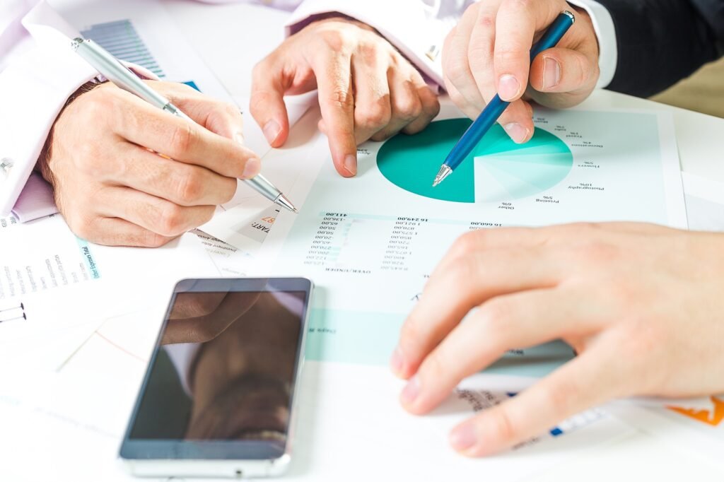 Business professionals collaborating on financial analysis and strategy development at an office
